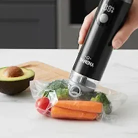 Vacuum-sealed bags of cucumber and steak sealed with a handheld vacuum sealer